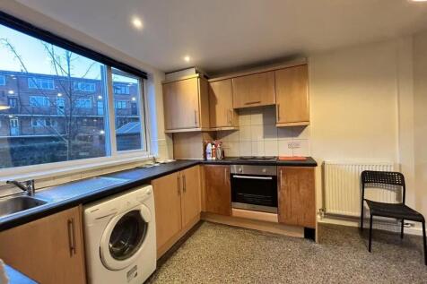 Well-lit kitchen featuring ample natural light ...