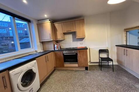 A spacious and well-maintained kitchen featurin...