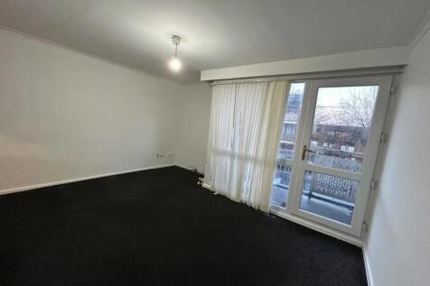 A spacious living room featuring large windows ...