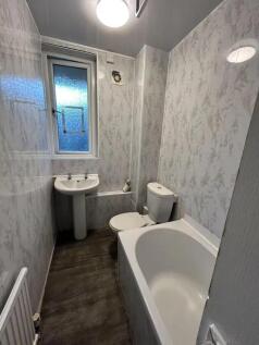 A clean and functional bathroom suite featuring...