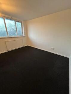 A clean and bright single bedroom with a large ...