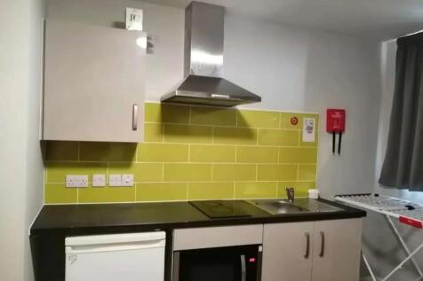 A modern kitchen space featuring a sleek black ...