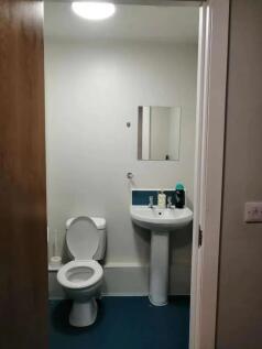 A clean and functional single toilet room featu...