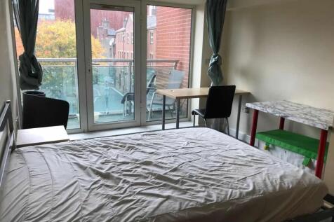 Bright double bedroom featuring a large window ...