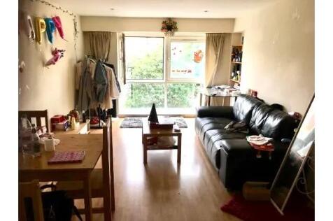 A cozy living room featuring a large window tha...