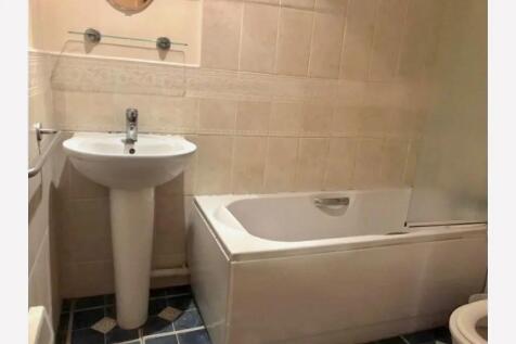 A neat and functional bathroom featuring a clea...