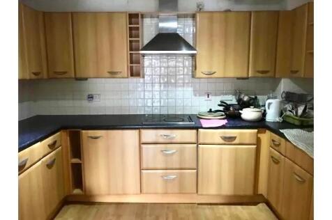 A well-organized kitchen featuring ample wooden...