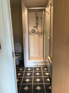 A neat and functional bathroom featuring a show...