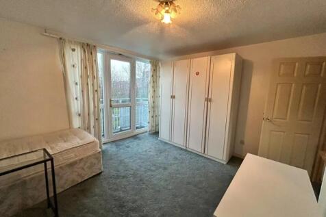 A bright double bedroom with a large wardrobe, ...