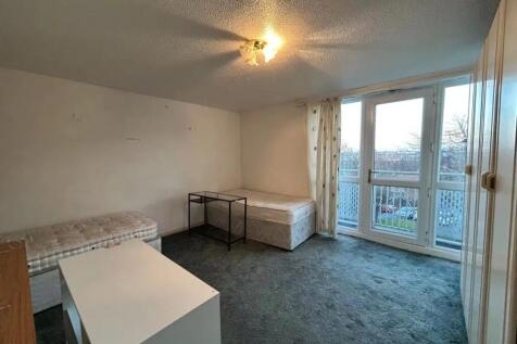 A spacious double bedroom featuring two single ...