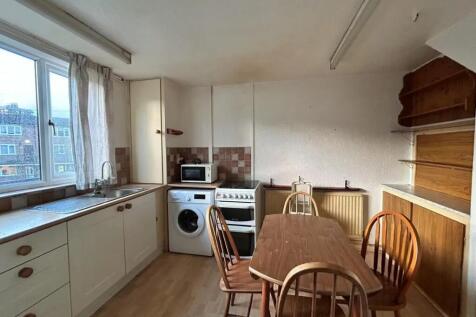 A bright kitchen featuring a large window with ...