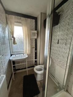 A compact and functional bathroom featuring a s...
