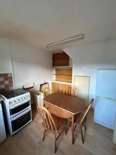 Cozy kitchen with a wooden dining table and fou...