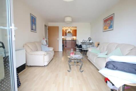 Bright living room featuring light wooden floor...