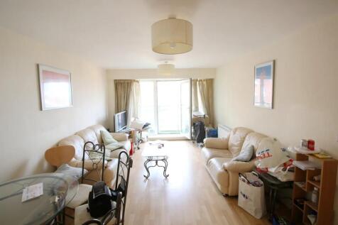 Bright living room featuring light wood floorin...