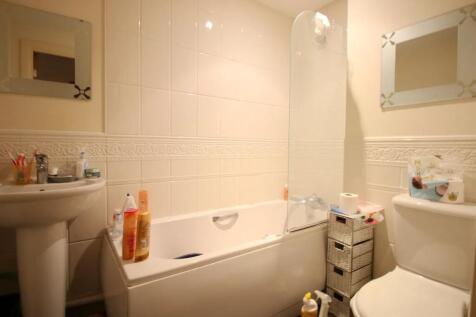 A clean and functional bathroom suite featuring...