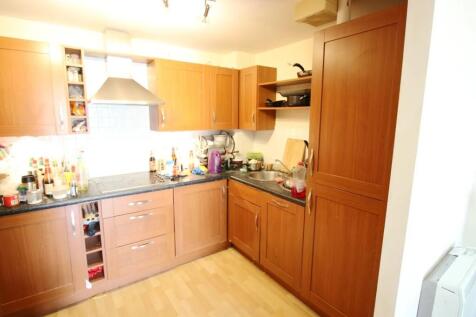 A bright kitchen featuring warm wooden cabinetr...