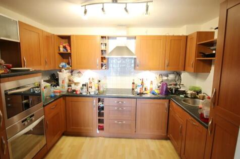 A warm and inviting kitchen featuring wooden ca...