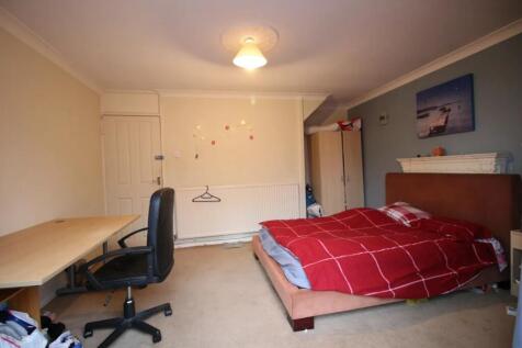 A spacious master bedroom featuring a large dou...