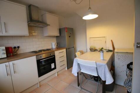 A functional kitchen space featuring modern whi...