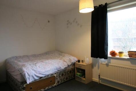 Cozy single bedroom featuring a comfortable bed...