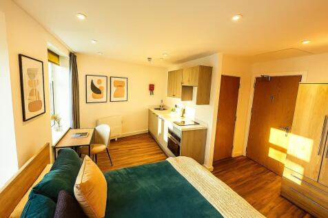 A bright and welcoming living room featuring la...