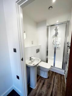 A clean and modern bathroom featuring a shower ...