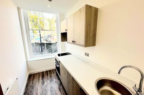 Modern kitchen with a large window providing ab...