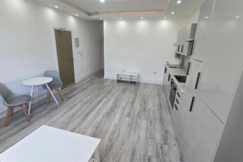 A modern, well-lit living room with clean, mini...