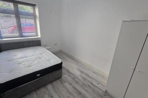 A clean and bright small bedroom with a window ...