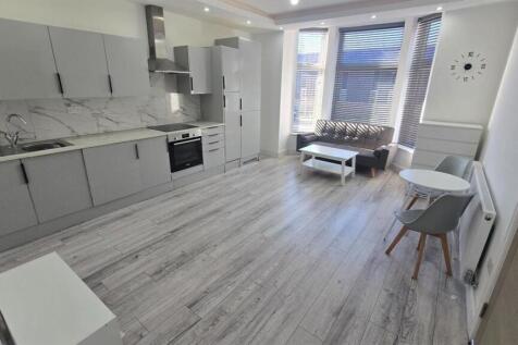 Bright and spacious living area with modern fur...