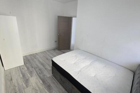 A small, clean toilet with minimal visible feat...