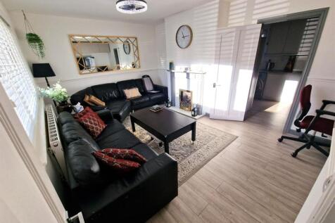 A bright and modern living room featuring a lar...