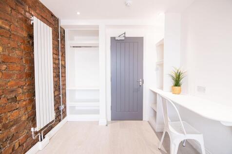 Bright, modern room with exposed brick feature ...