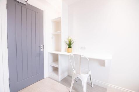 Bright, minimalist study nook with a built-in w...