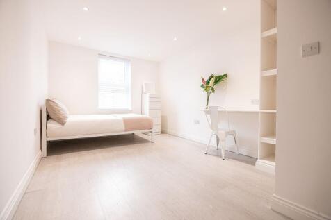 Bright, minimalist single bedroom with a comfor...