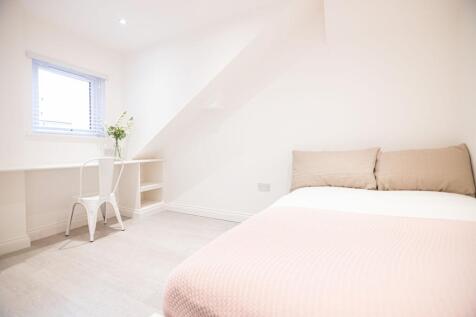 Bright, neatly presented bedroom with a comfort...
