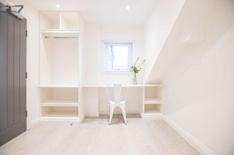 Bright, freshly painted workspace with built-in...