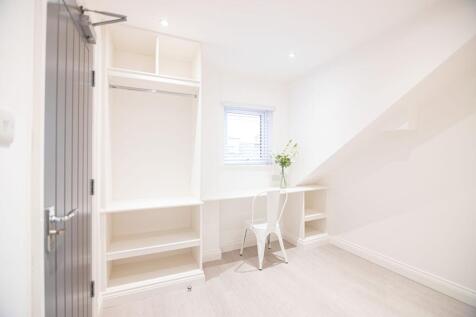 Bright, freshly decorated bedroom with built-in...