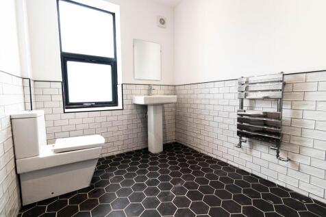 Bright modern bathroom with large frosted windo...