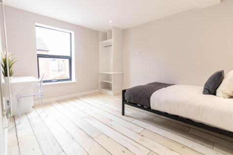 Bright, modern bedroom with large window, pale ...