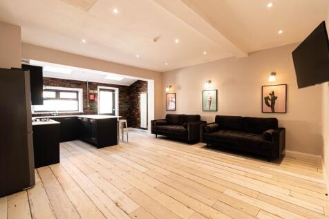 Bright, open-plan living space with light wood ...