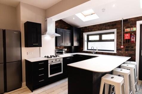 Contemporary kitchen with a long white breakfas...