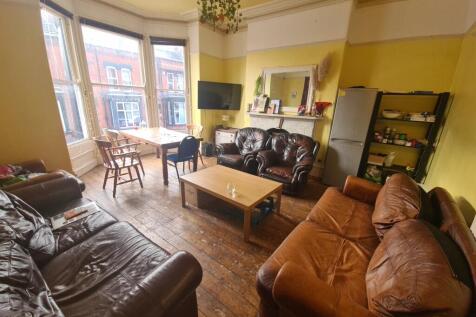 A spacious and inviting living room featuring m...