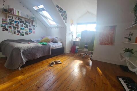 Bright and spacious master bedroom with sloped ...