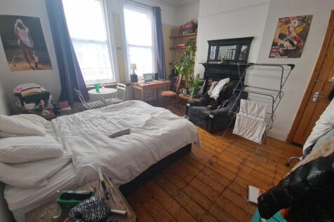 A bright and inviting master bedroom featuring ...