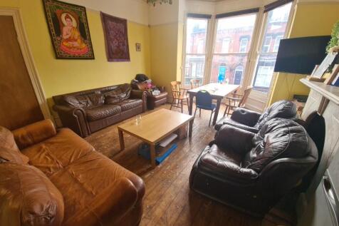 A cozy and inviting living room featuring large...