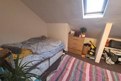 Cozy bedroom featuring a skylight that provides...