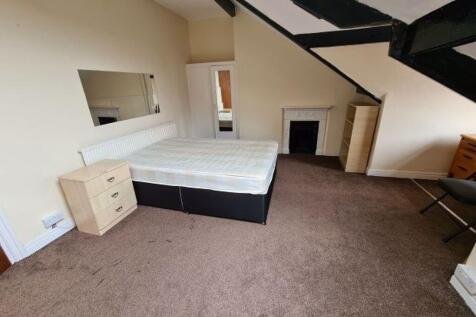 Spacious master bedroom featuring a large bed, ...