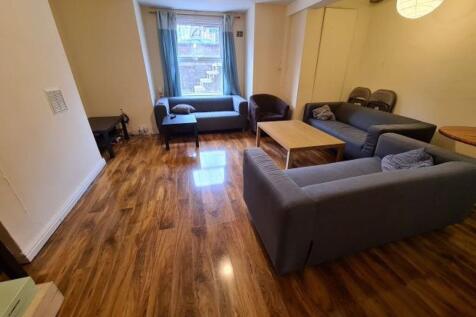 A modern living room featuring polished wooden ...